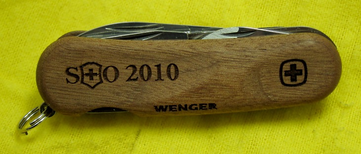 The SOSAK 2010 KOTY is a Wenger Evo-Wood 18 with the SOSAK logo and year imprinted on the top scale.  The Evo-Wood Series was first introduced in 2010.