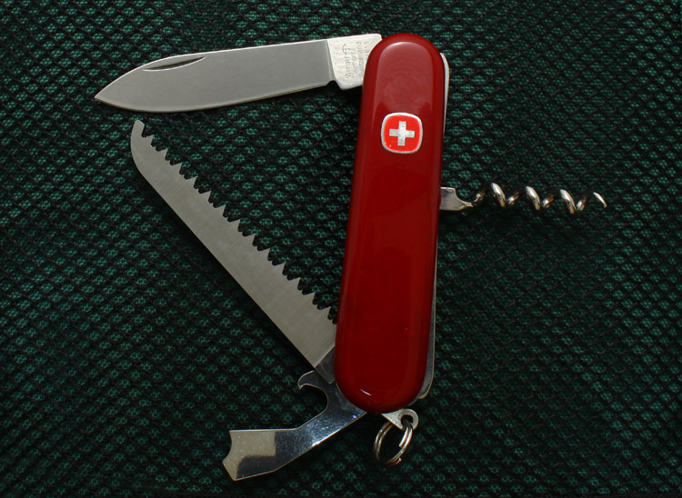 A vintage Wenger 85mm knife now known as the Classic 66 (yr. 2011), but it likely had a different name when it was current.  This model differs from the current version in that it does not include the toothpick or tweezers.  Some refer to this 85mm knife as a Wenger Lumberjack with reference to the very similar 84mm Victorinox Lumberjack.  Basically this model is a Wenger Entree with a wood saw added.