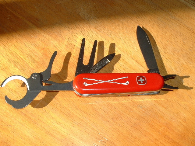 Special golfers knife with a cigar cutter made by Wenger. The Club Face Cleaner is not shown, but is where you would normally find the Reamer.